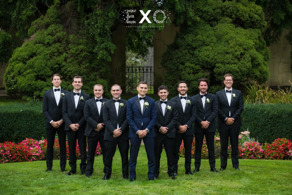 groom and his groomsmen outside The Mansion at Oyster Bay