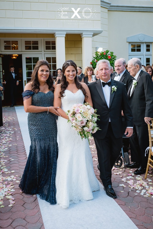 bride being walked down the aisle by her parents at The Mansion at Oyster Bay