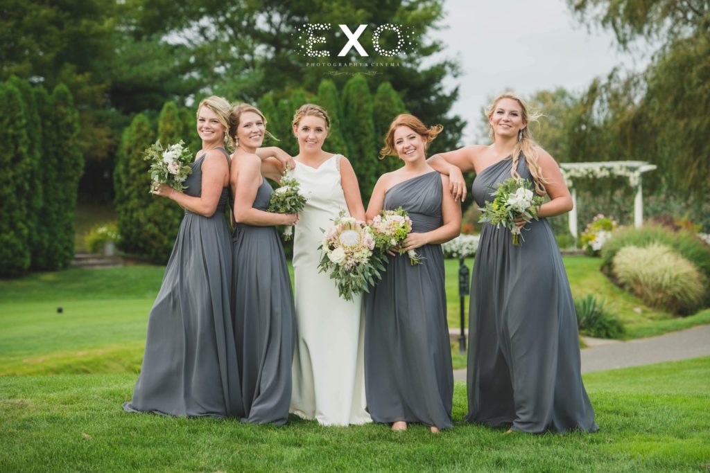 bride and bridesmaids having fun outside Willow Creek Golf and Country Club