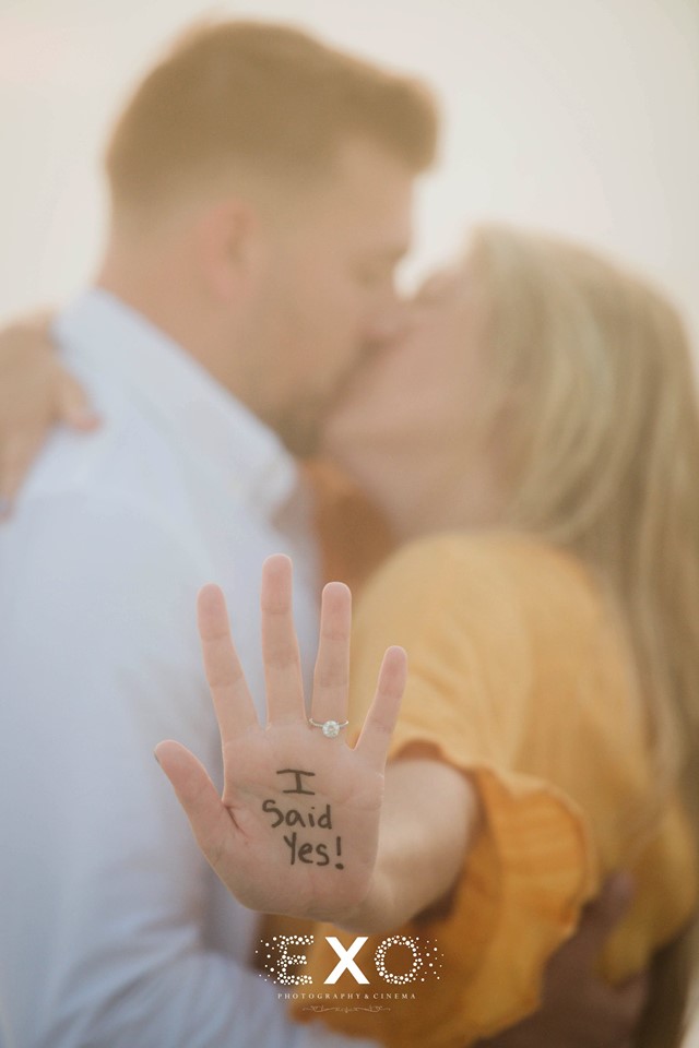 couple kissing with "I said yes!" written on hand