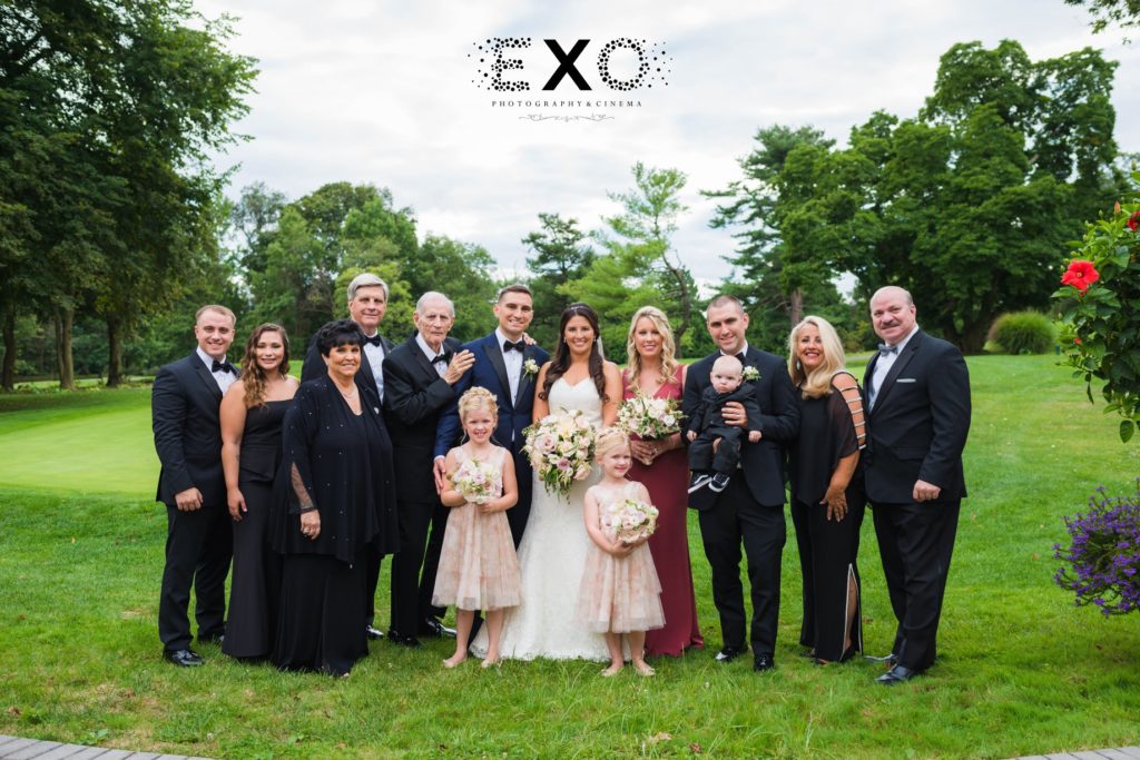 bride and groom with family outside The Mansion at Oyster Bay