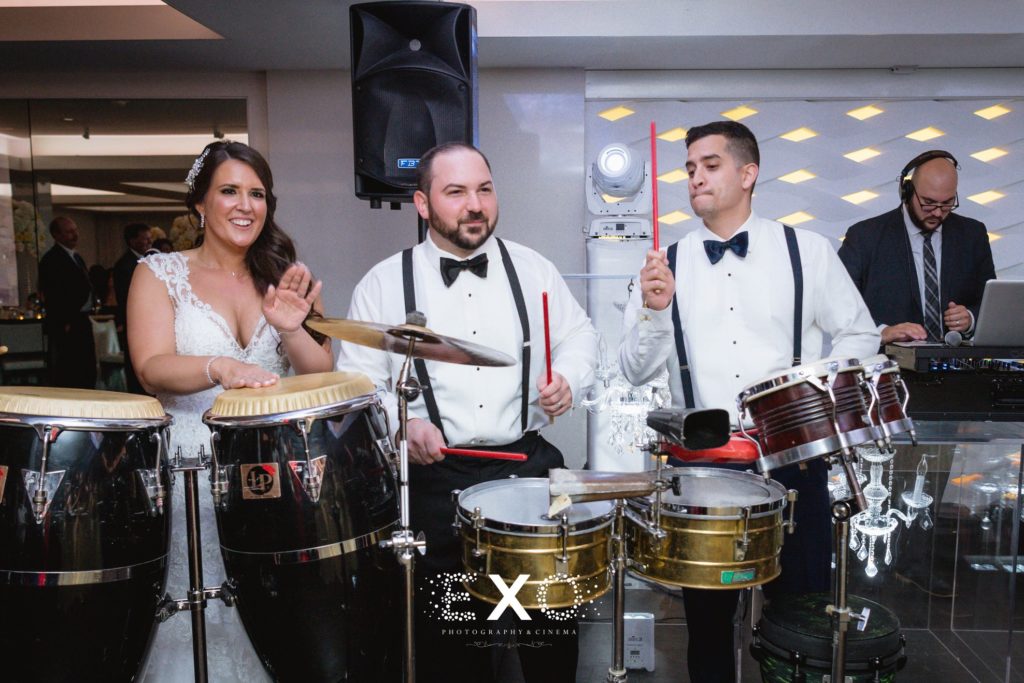bride and groom playing the drums with the band