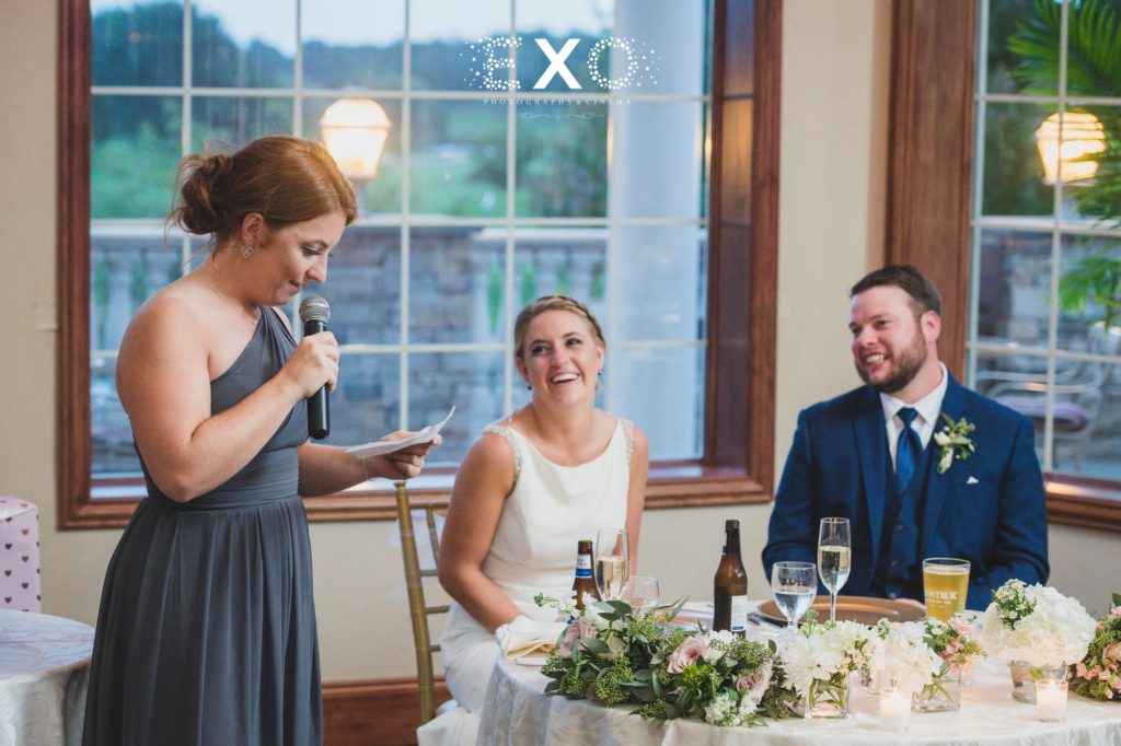 bride and groom laughing as bridesmaid gives speech at Willow Creek Golf and Country Club