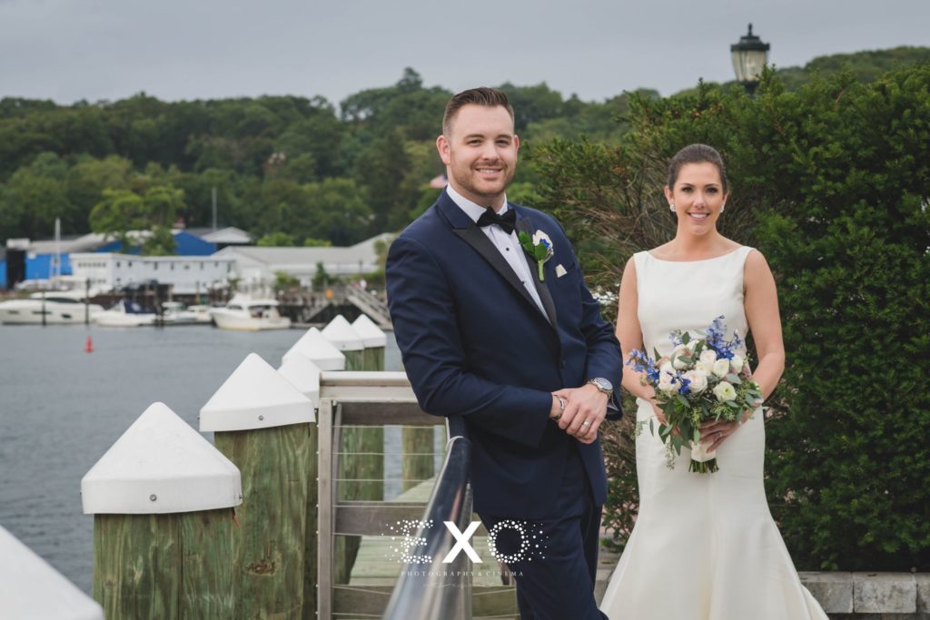 bride and groom smiling outside Harbor Club at Prime