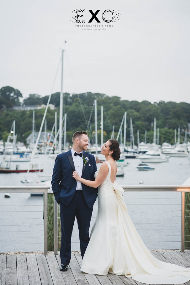 bride and groom standing on the dock at Harbor Club at Prime