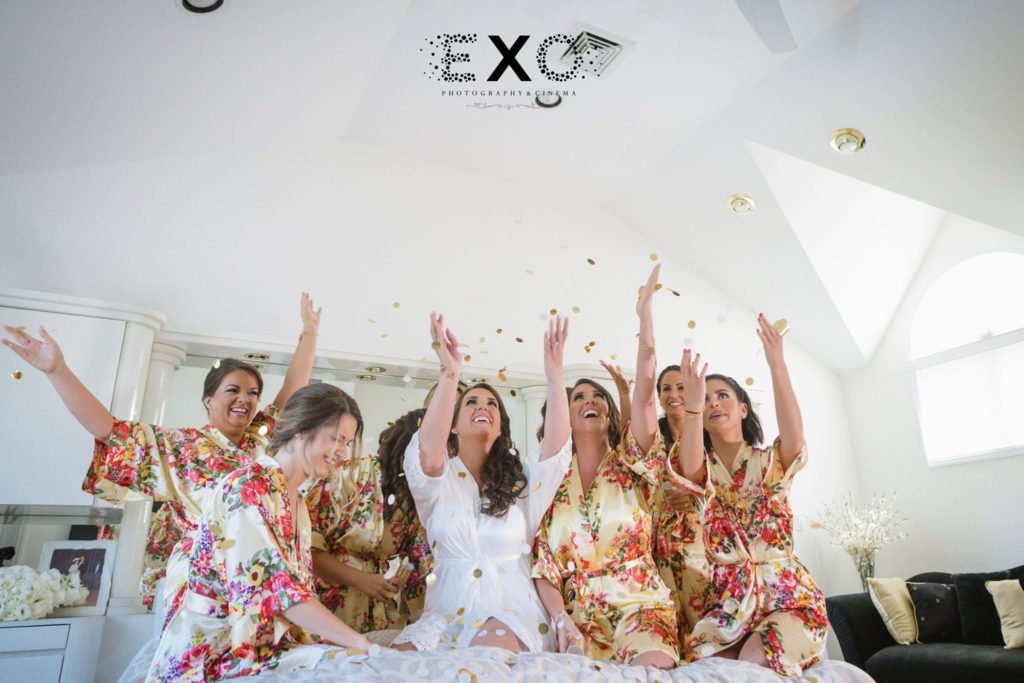 bride and bridesmaids throwing confetti