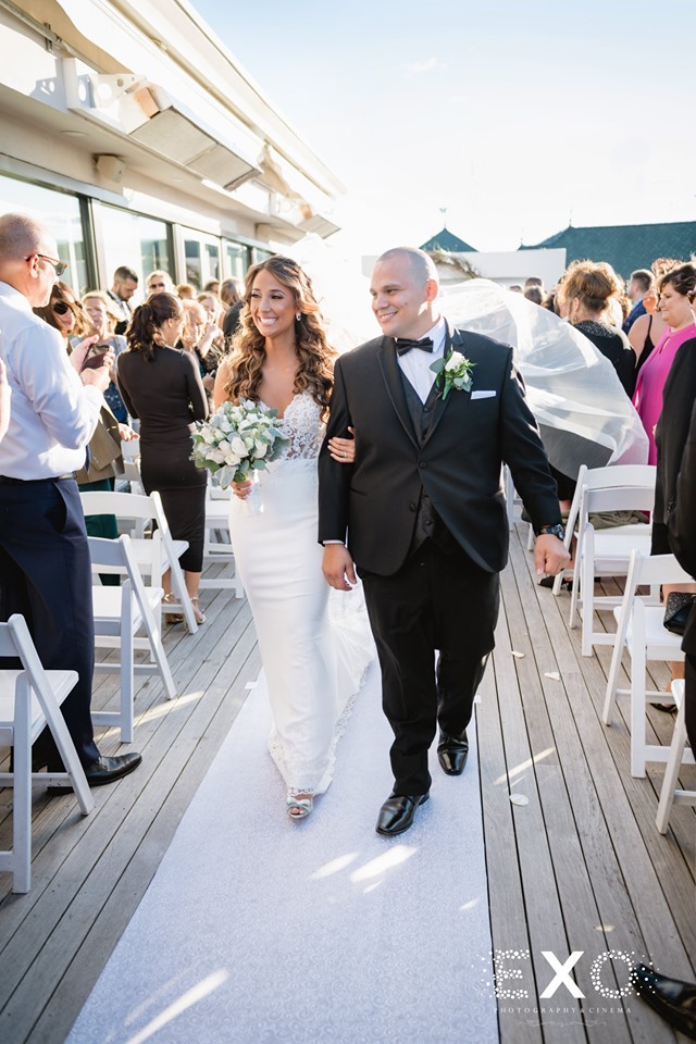 bride and groom leaving the ceremony at Harbor Club at Prime