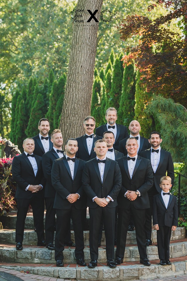 groom and groomsmen posing at The Muttontown Country Club