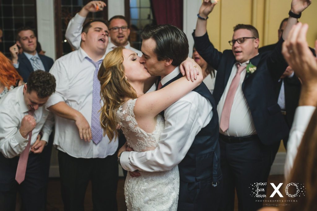 bride and groom kissing during their reception at Coindre Hall