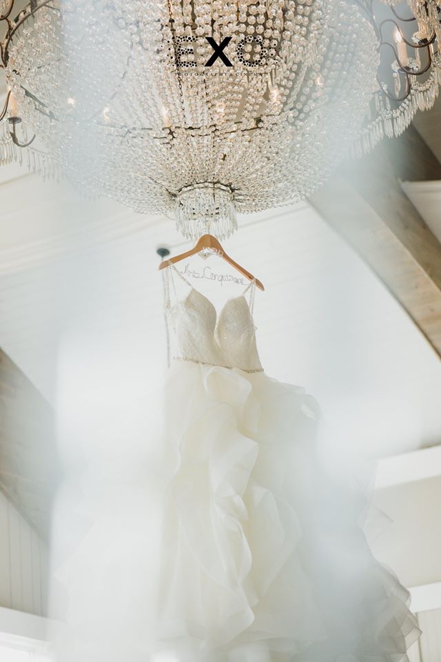 bride's dress hanging from the chandelier