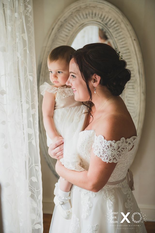 bride and flower girl looking outside