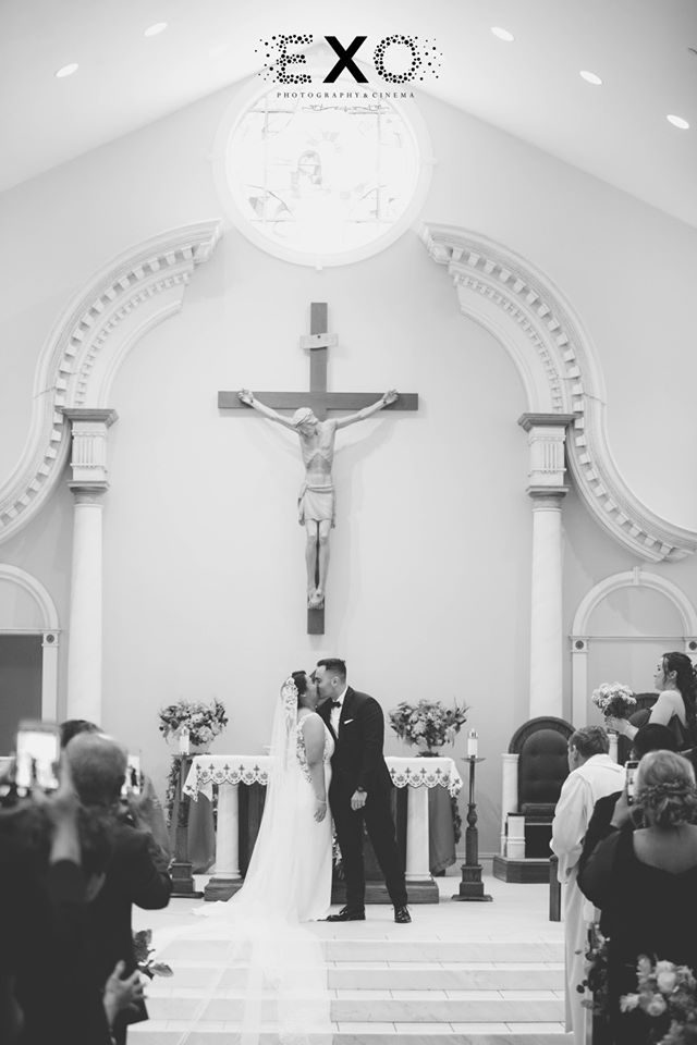 bride and groom kissing in church