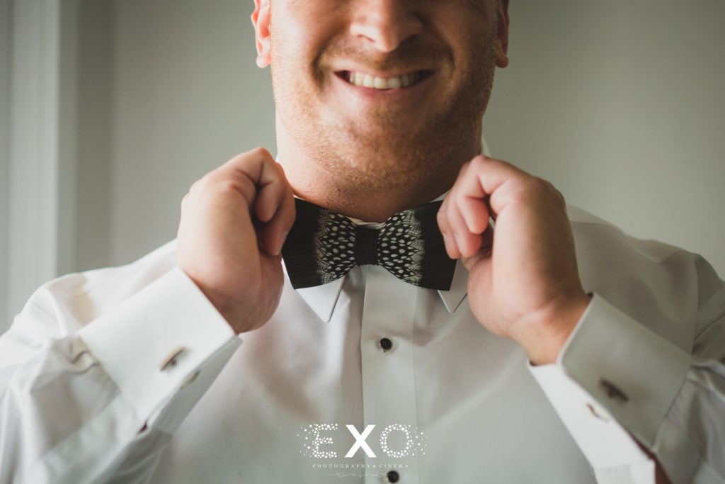 groom putting on his bowtie
