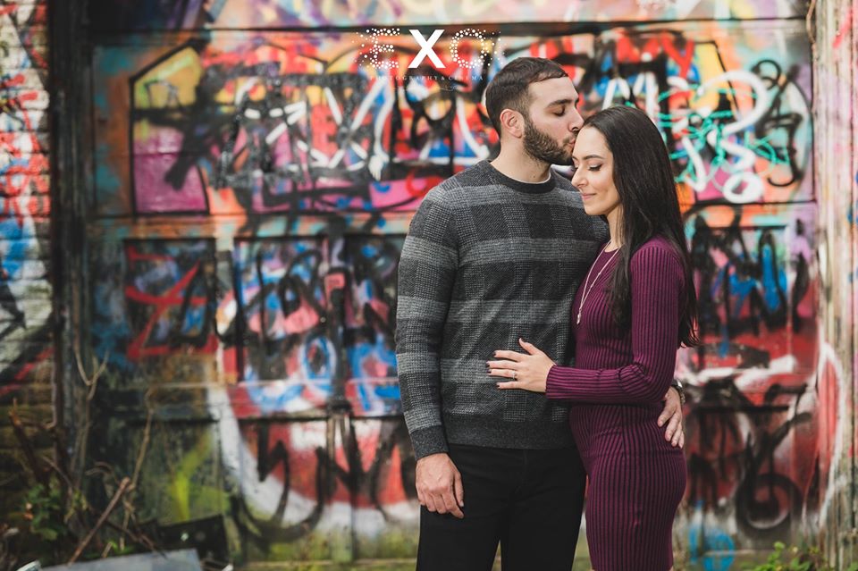 couple in front of graffiti wall