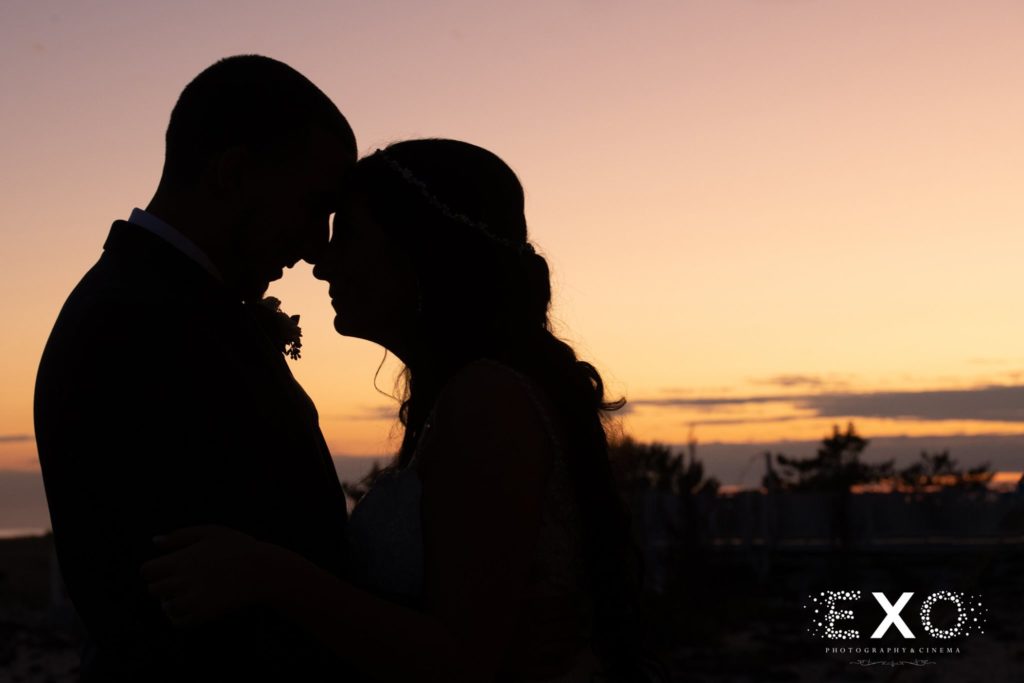 bride and groom locking eyes during sunset at Oceanbleu