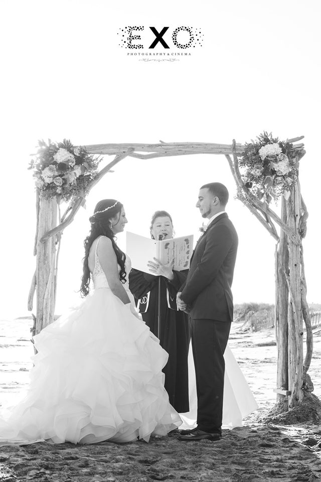 bride and groom exchanging vows on the beach