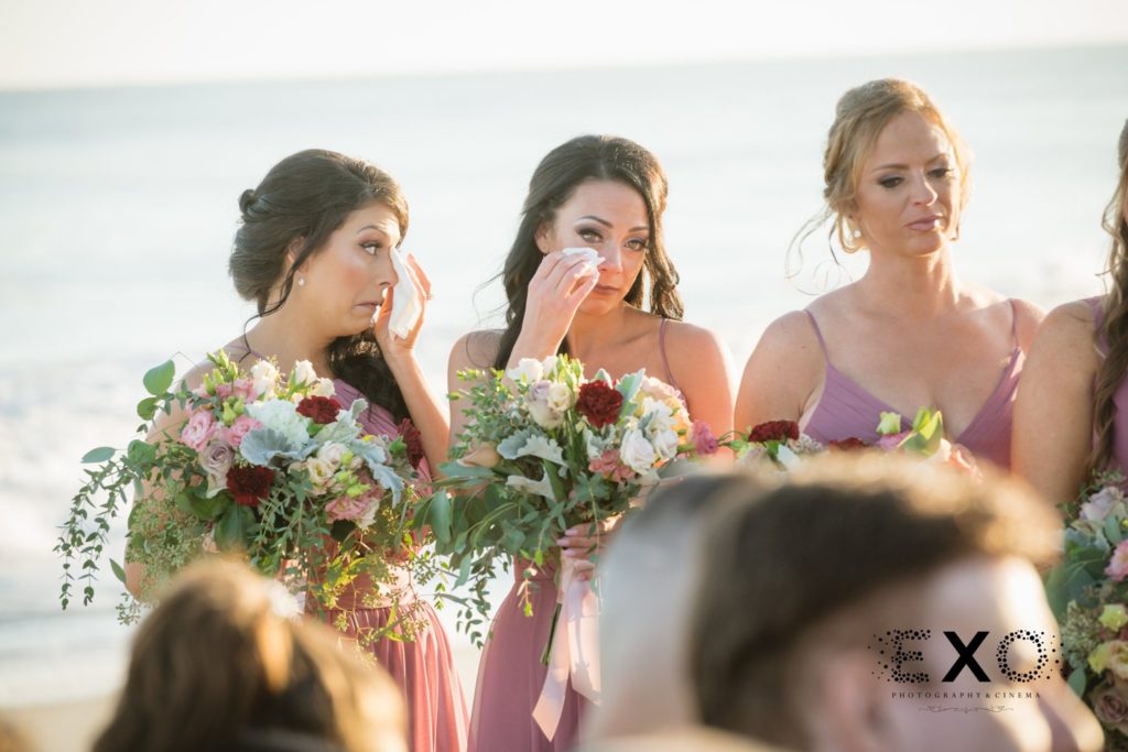 bridesmaids crying during ceremony at Oceanbleu