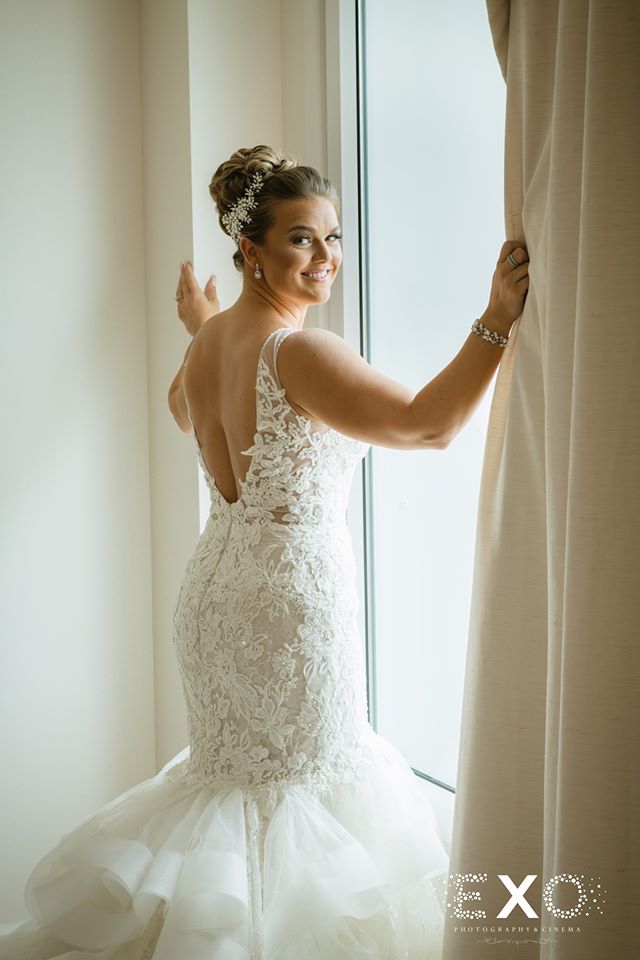 stunning bride standing in window