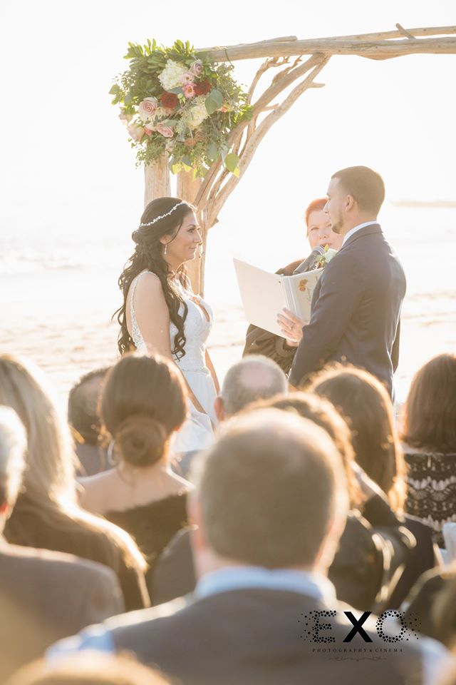 bride and groom exchanging vows at Oceanbleu