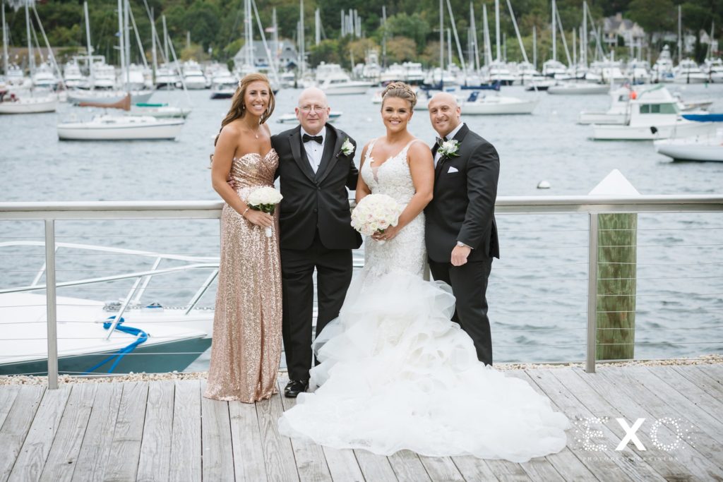 bride and groom on the dock at Harbor Club at Prime with family