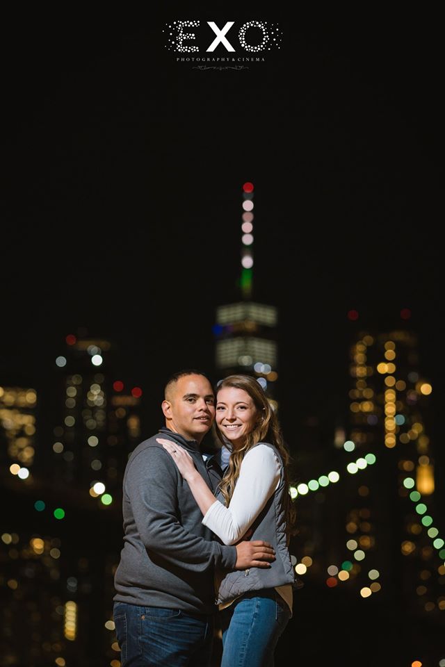 couple smiling at night in DUMBO