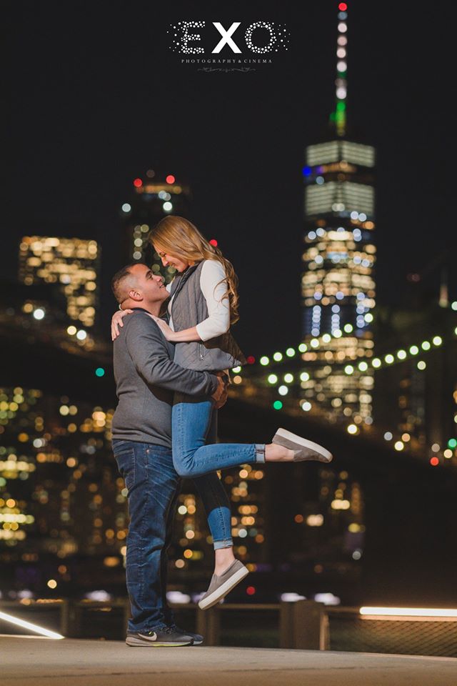 soon-to-be-groom holding his soon-to-be-bride in DUMBO