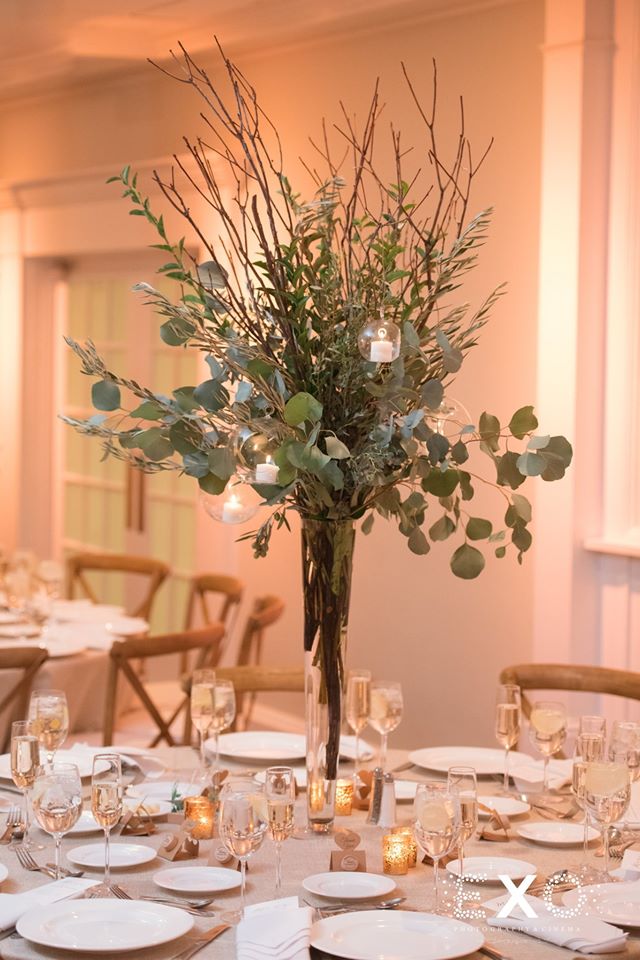 centerpiece filled with greenery and candles