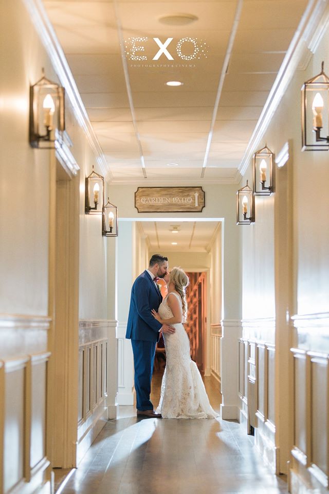 bride and groom kissing in the hallway at The Vineyard at Aquebogue