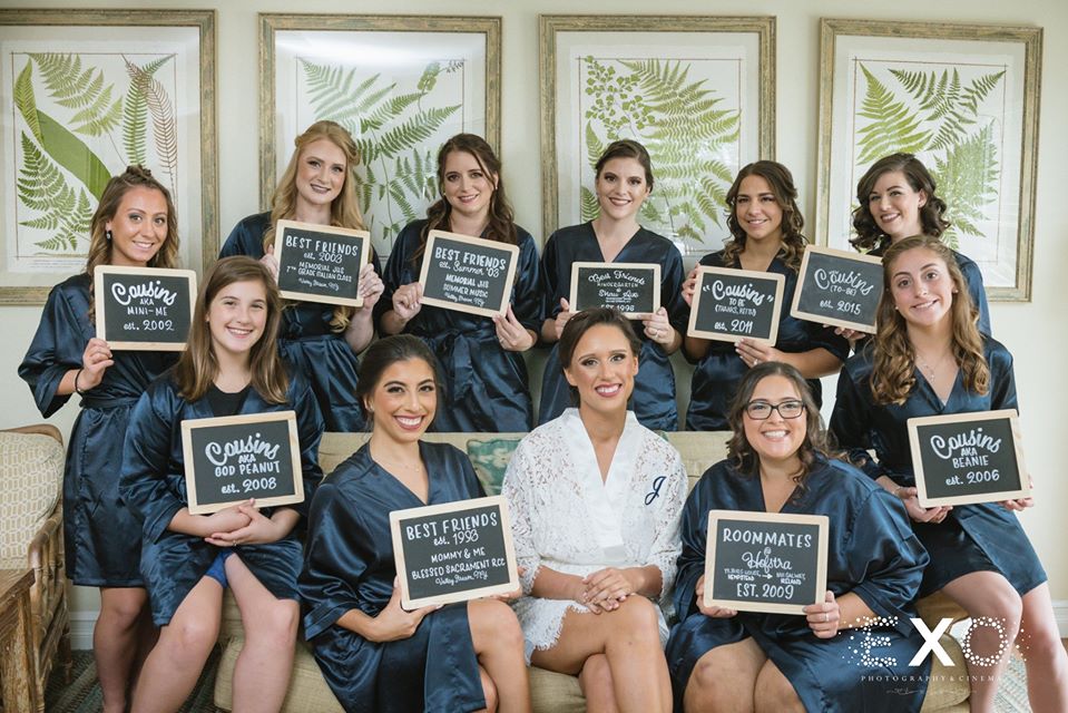 bride and her bridesmaids in their robes with signs