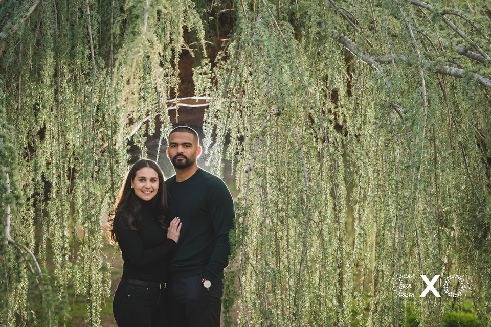 couple posing in the greenery at Planting Fields Arboretum