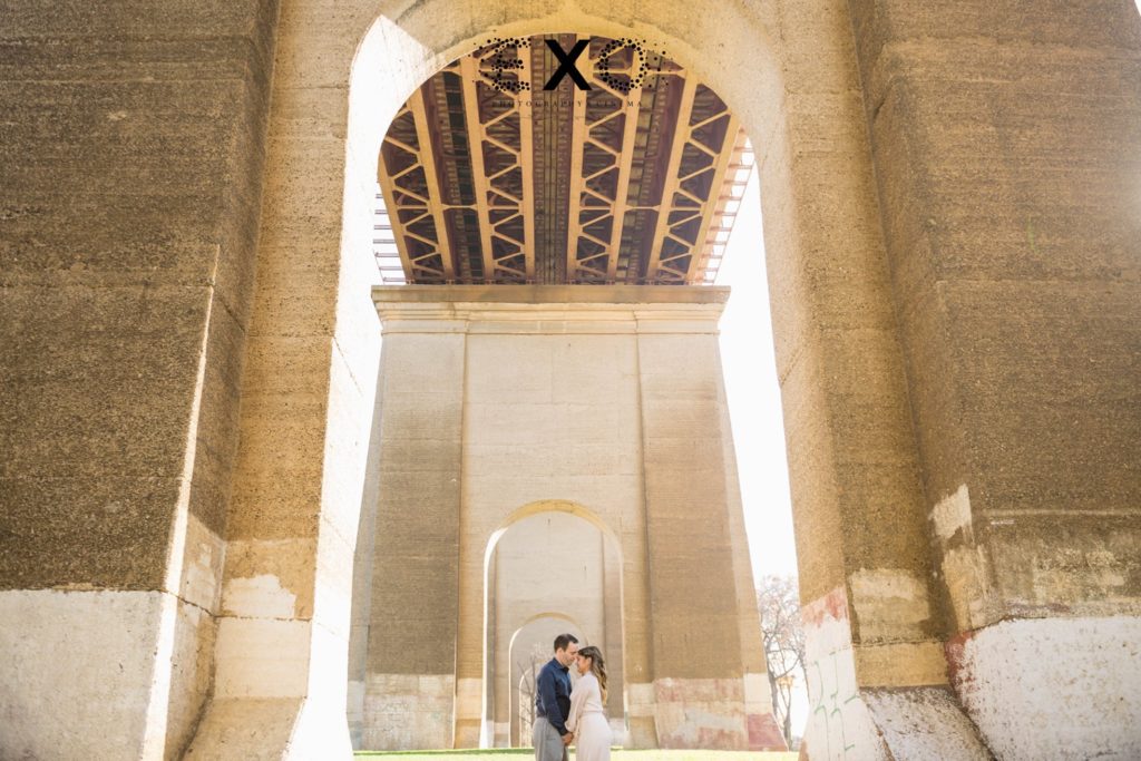 couple looking at one another under the archway