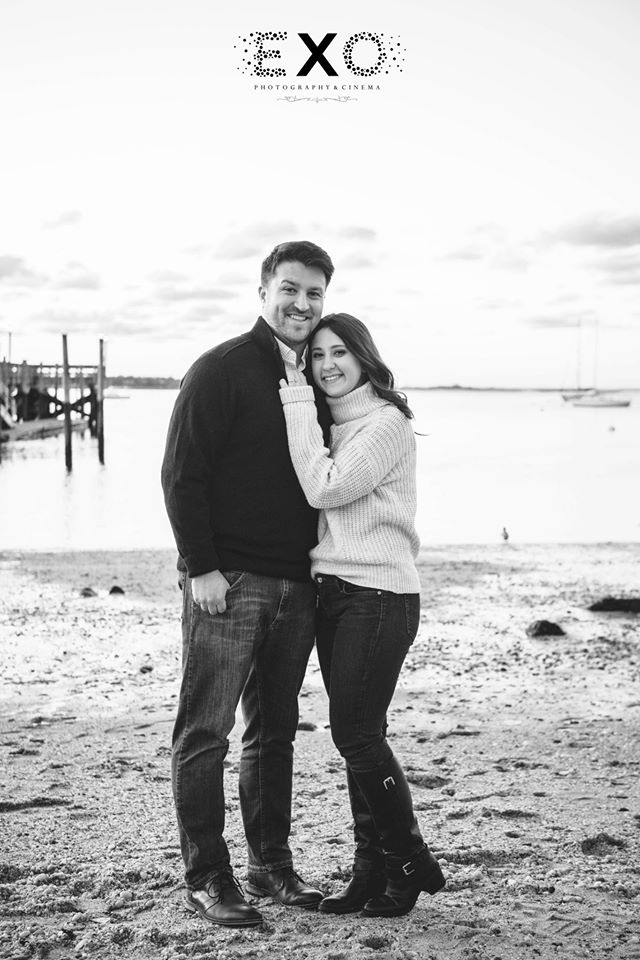 couple standing by the water at Port Jefferson