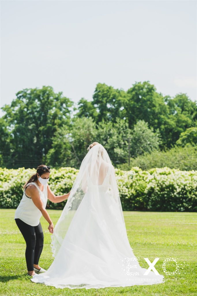 bride getting some help with her veil for the photos