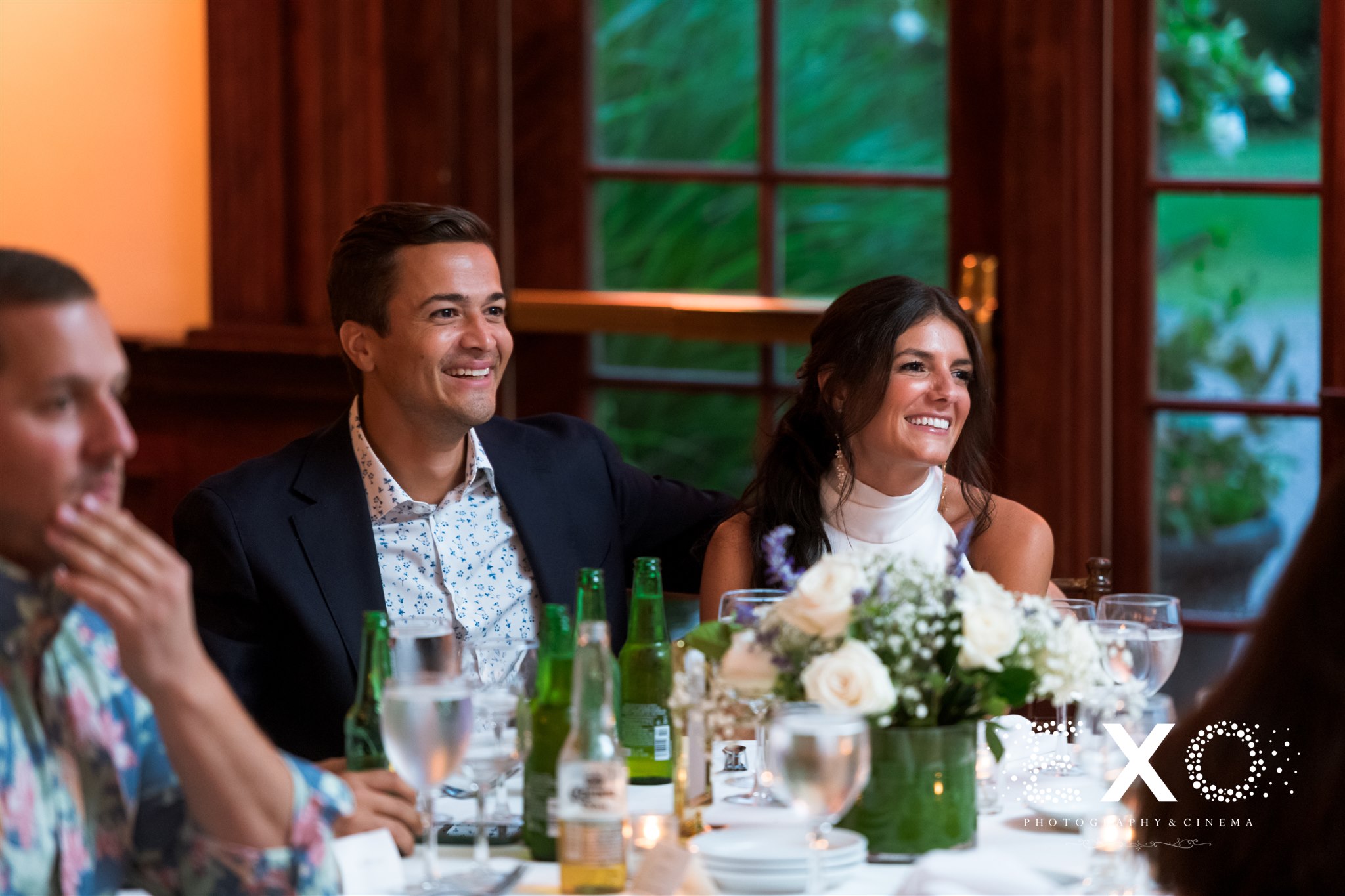bride and groom smiling during a toast at the Mansion at Oyster Bay
