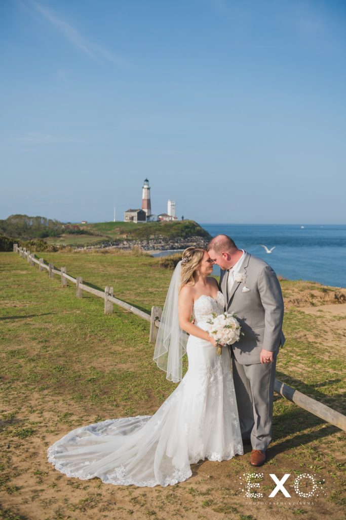 bride and groom kissing in front of the lighthouse at 360 East