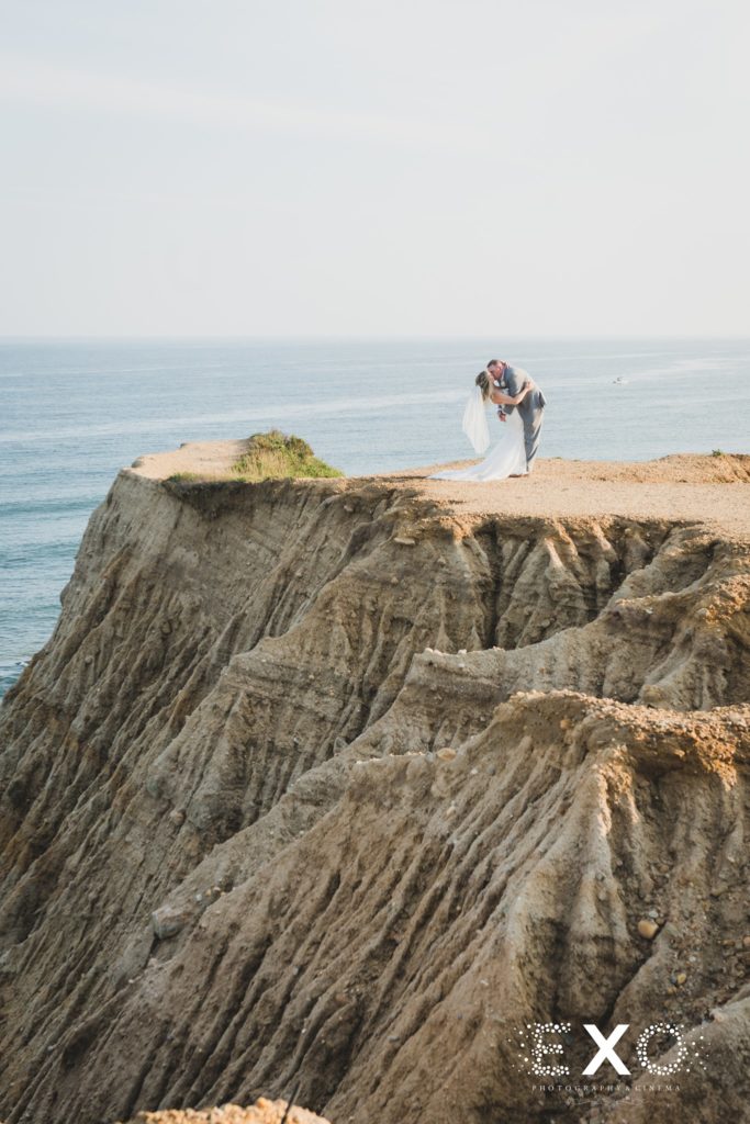 bride and groom kissing on the cliff at 360 East