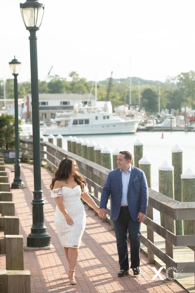 couple walking along the boardwalk at Harbor Club at Prime