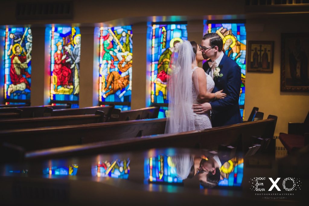 bride and groom kissing in the church alone