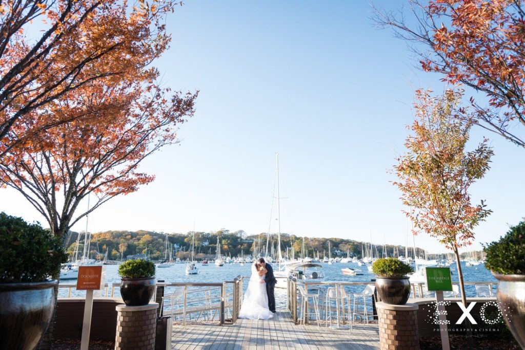 bride and groom kissing on the dock at Harbor Club at Prime