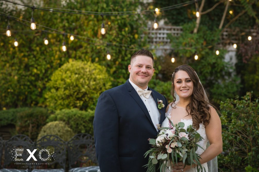 bride and groom smiling in the courtyard at Fox Hollow