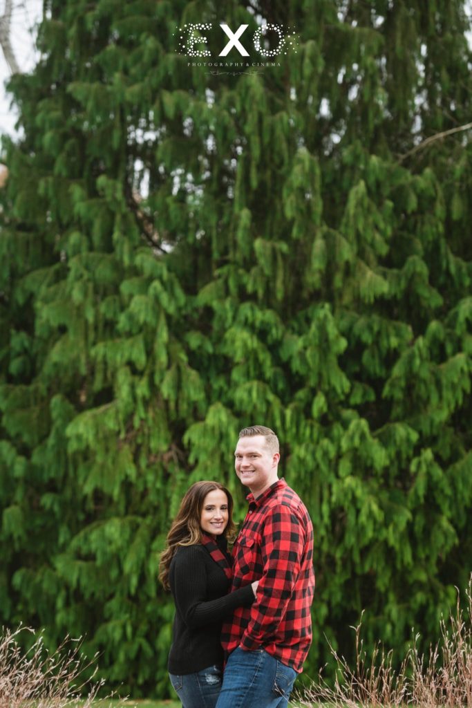 couple smiling in front of giant tree