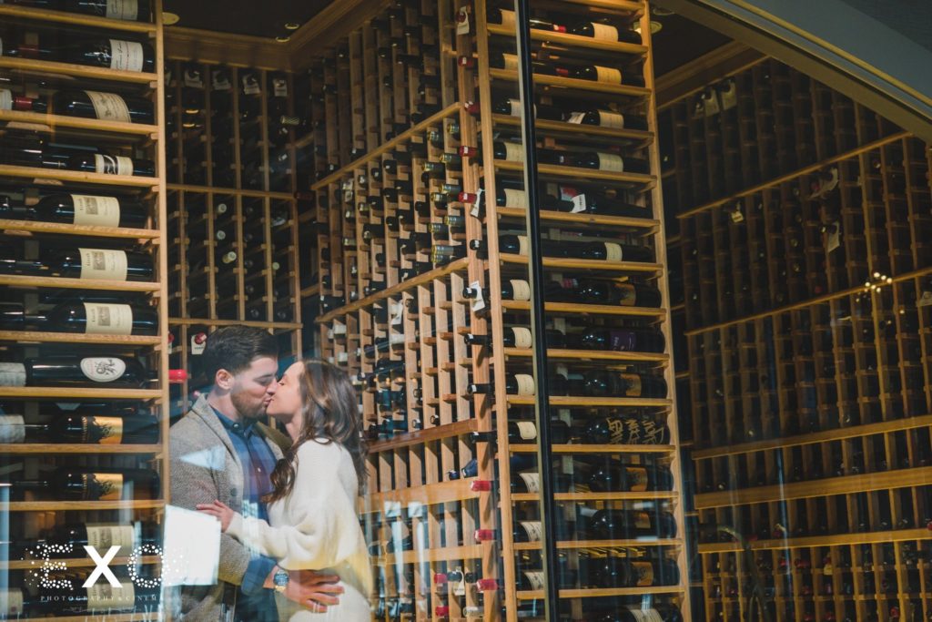 couple kissing in the wine cellar at Prime Steakhouse