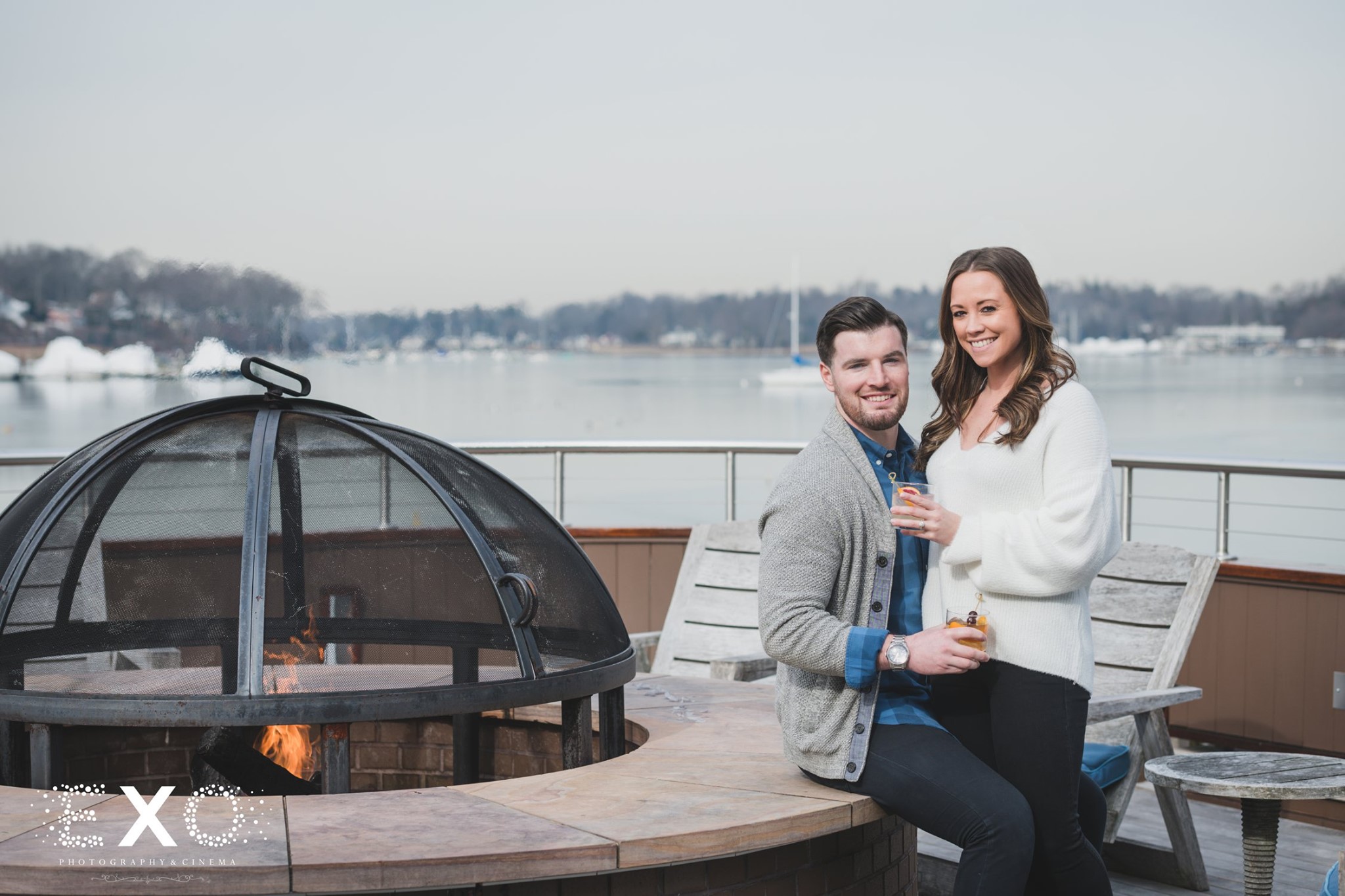 couple standing by the fire pit