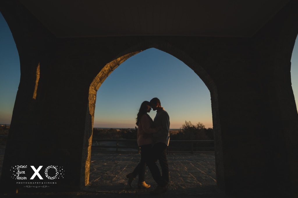 couple holding each other during sunset