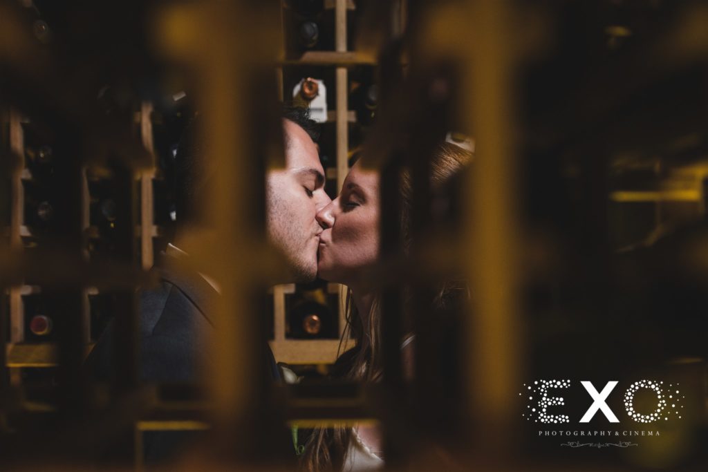 bride and groom kissing in the wine cellar at Harbor Club at Prime