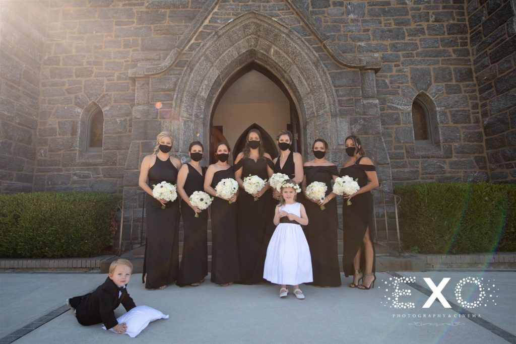 Bridesmaids at the steps of the church before a Fall wedding at Harbor Club at Prime
