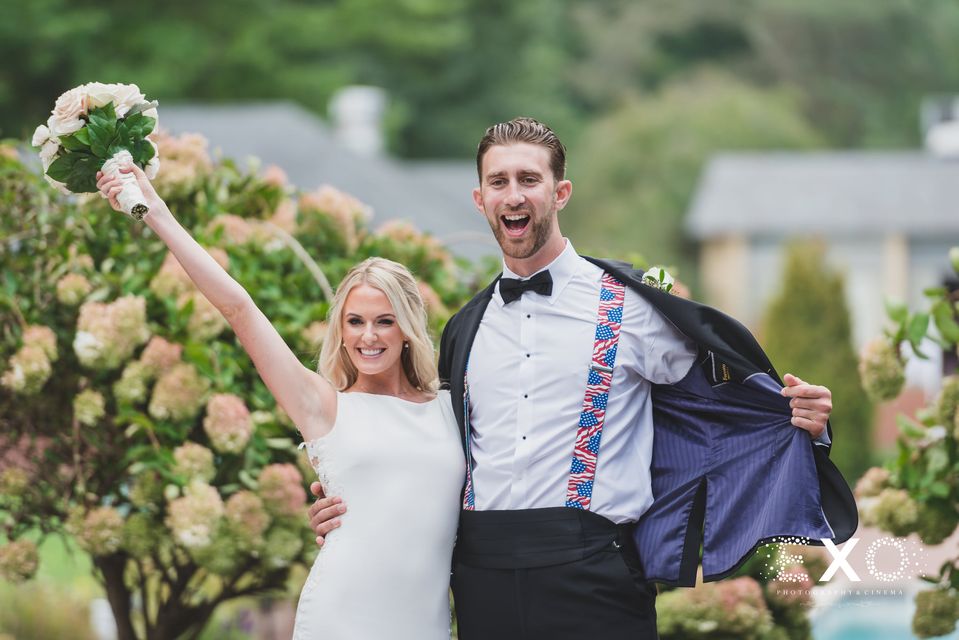 bride and groom with suspenders visible
