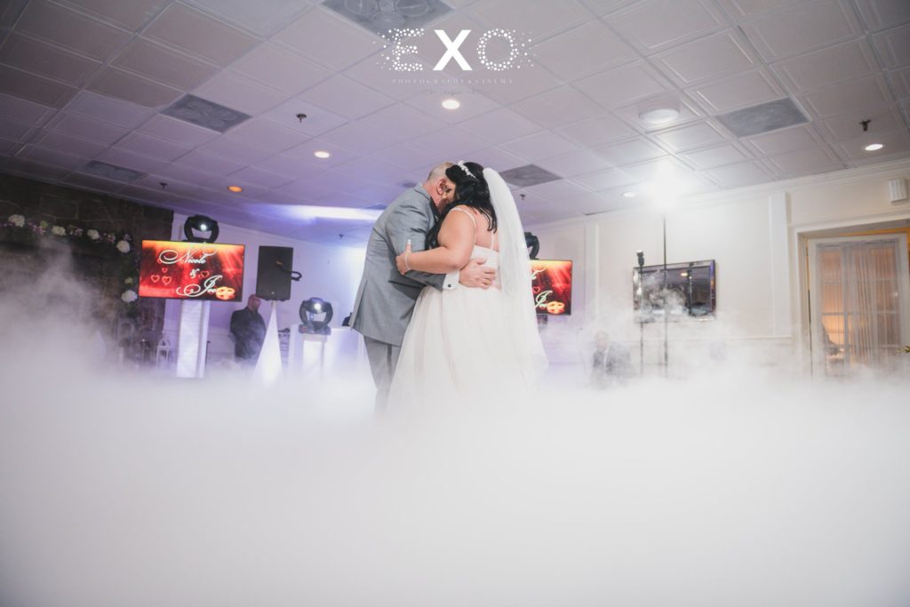 bride and groom dance with smoke