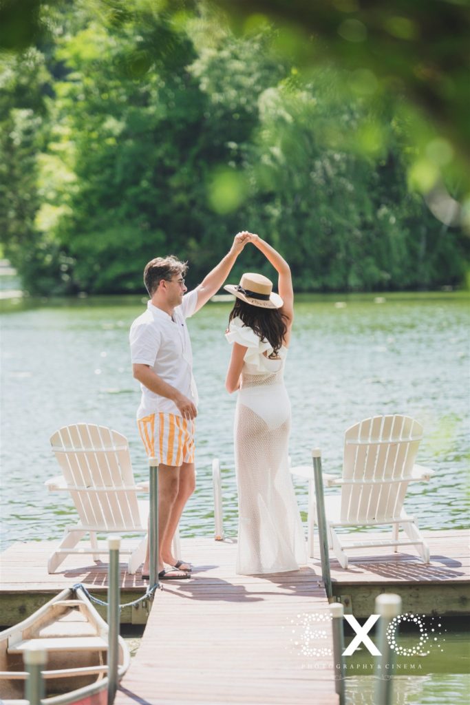 bride and groom dancing on dock twirling