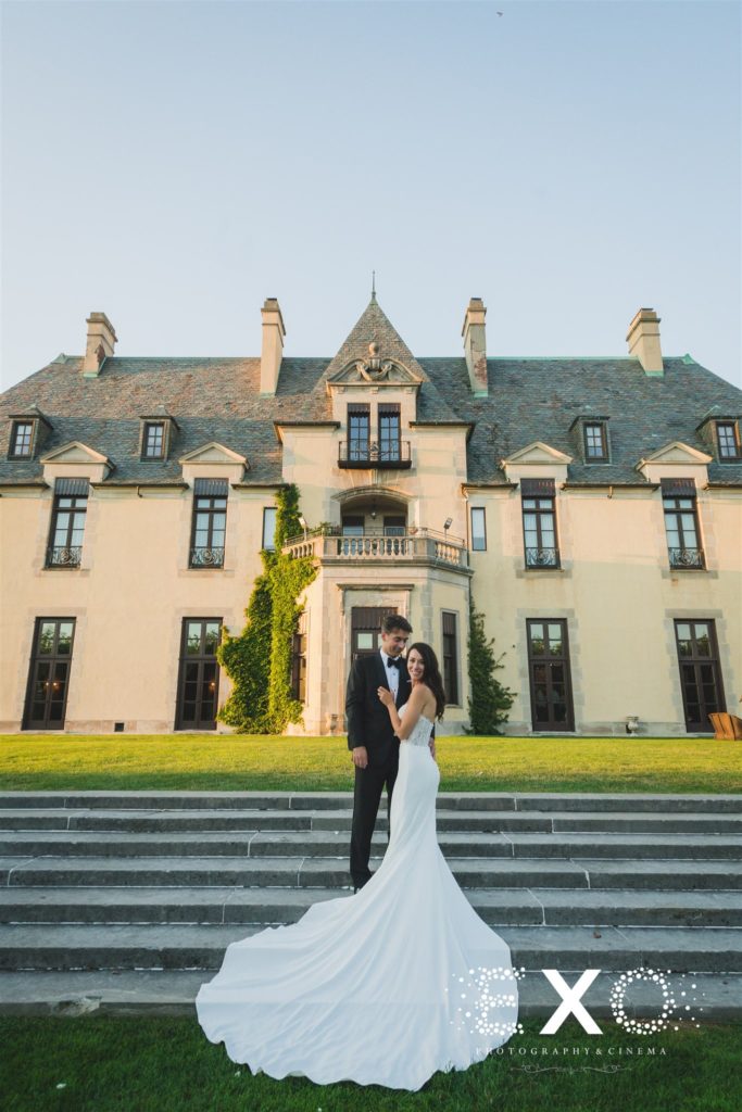 bride and groom in front of castle